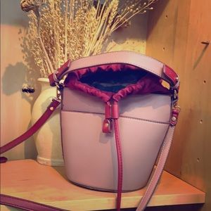 Pink bucket bag with red accents